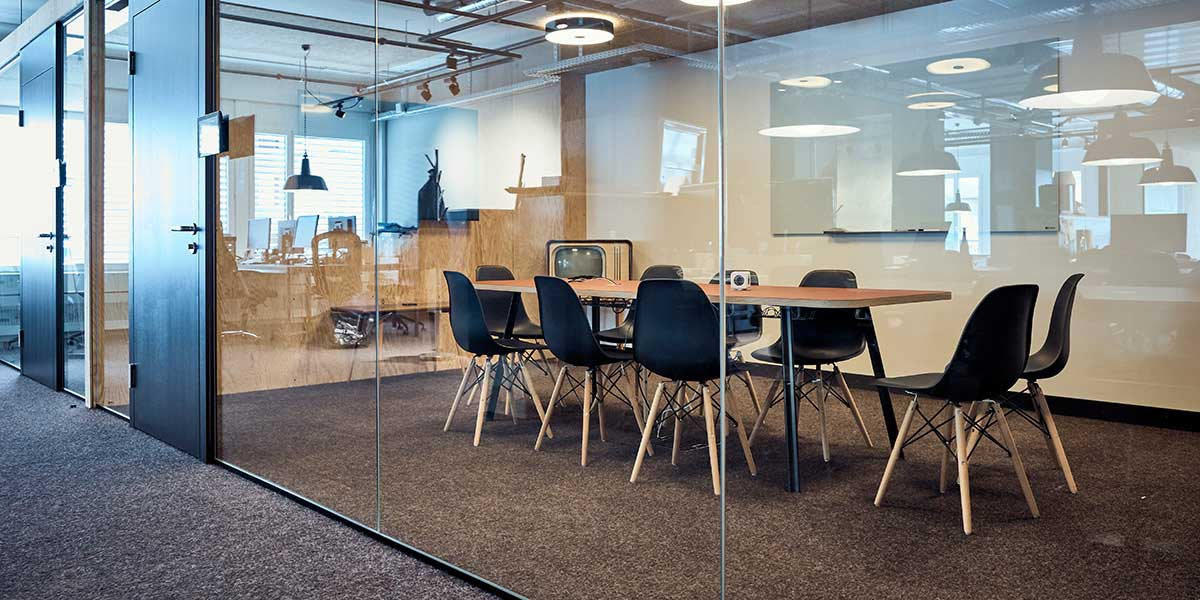 Meeting room with glass wall, table and chairs